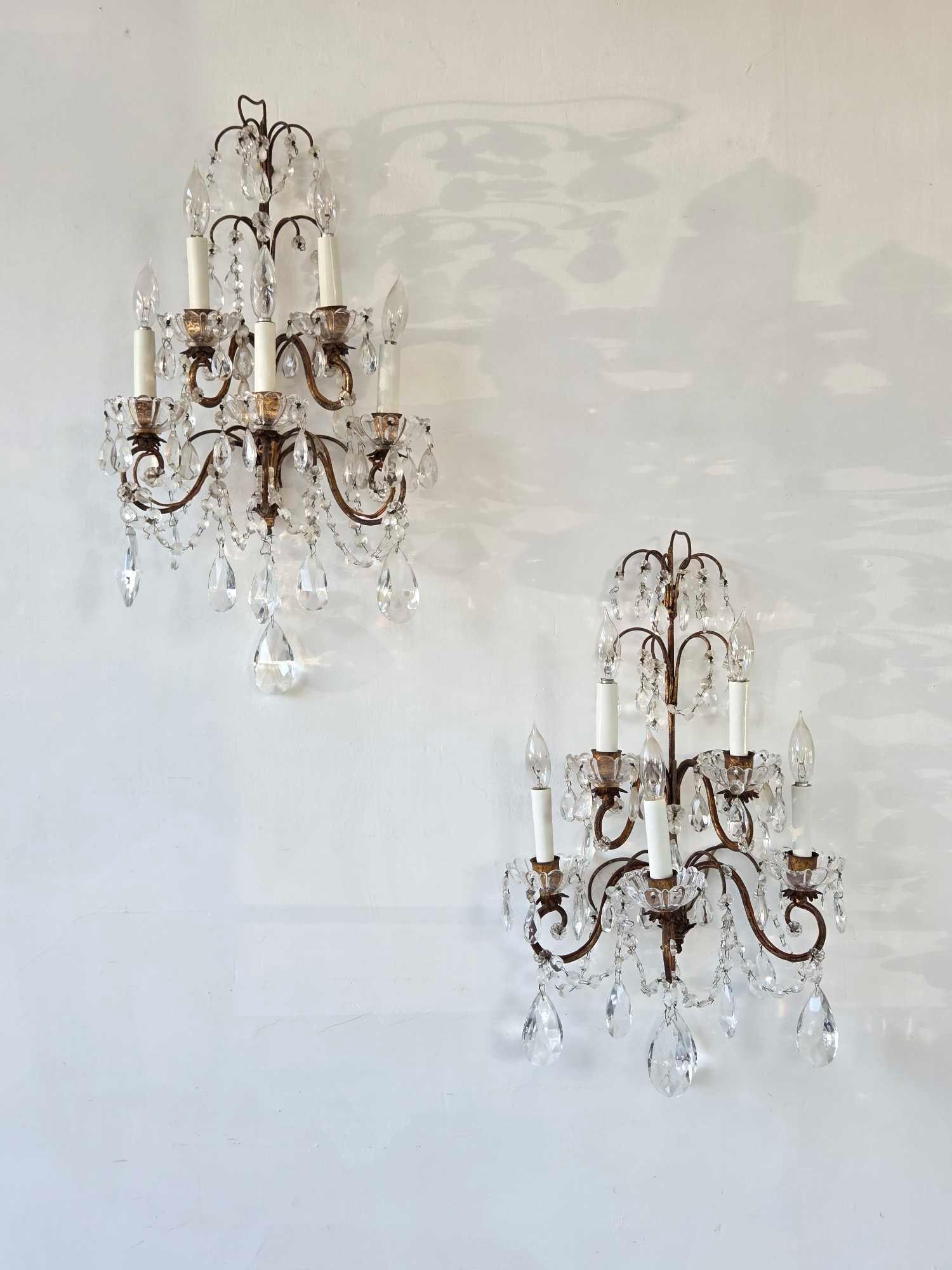 VINTAGE PAIR OF ITALIAN GILT METAL AND CRYSTAL FIVE-LIGHT SCONCES: Pair of Italian gilt metal and crystal five-light wall sconces Approximate Dimensions: 22.5" H x 12" W x 8" D Artist or Maker: Unnown Provenance: From a New York Collector Notes: Although 