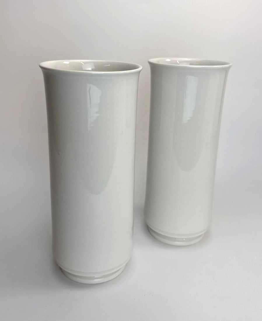 PAIR OF TRUDE PETRI FOR KPM BERLIN WHITE PORCELAIN CYLINDER VASES, BLUE SCEPTER MARK, GERMANY: Pair of white glazed porcelain cylinder vases, slightly flared rim over a stepped circular foot. Approximate Dimensions: 11" H x 4 1/2" Dia. Artist or Maker: Trude Petri for KPM Berlin (Koenig