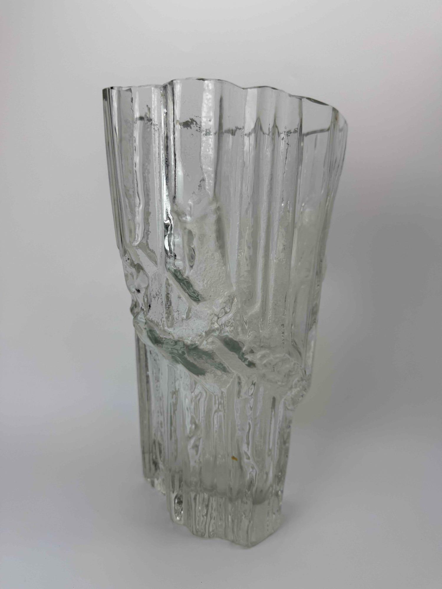 TAPIO WIRKKALA IITTALA AVENA TEXTURED GLASS VASE, LARGE, FINNISH ART GLASS: Large clear glass vase, deeply ribbed and bark-textured exterior rising to an irregular scalloped rim over a solid tapering foot Approximate Dimensions: 13" H x 8" W Artist or Maker: Tapio Wir