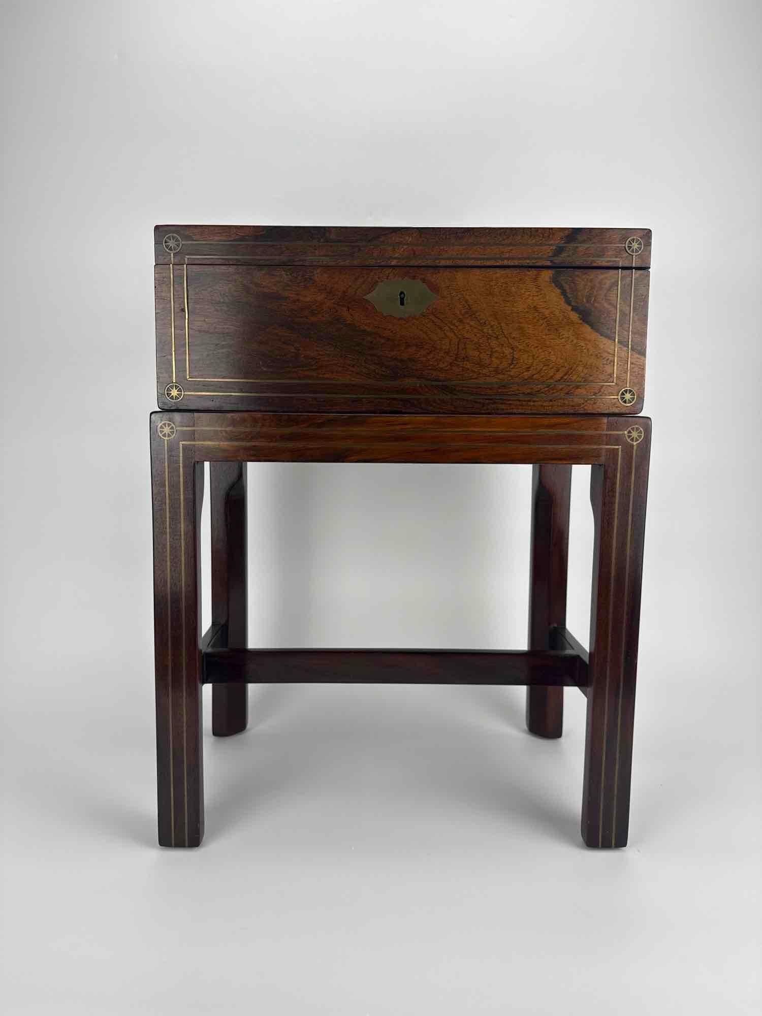 ROSEWOOD LAP DESK WRITING SLOPE ON STAND: Rosewood lap desk or writing slope on a later four leg stand. Approximate Dimensions: 21" H x 16.5" W x 10" D Artist or Maker: Unknown Provenance: From a New York Collector Notes: Although