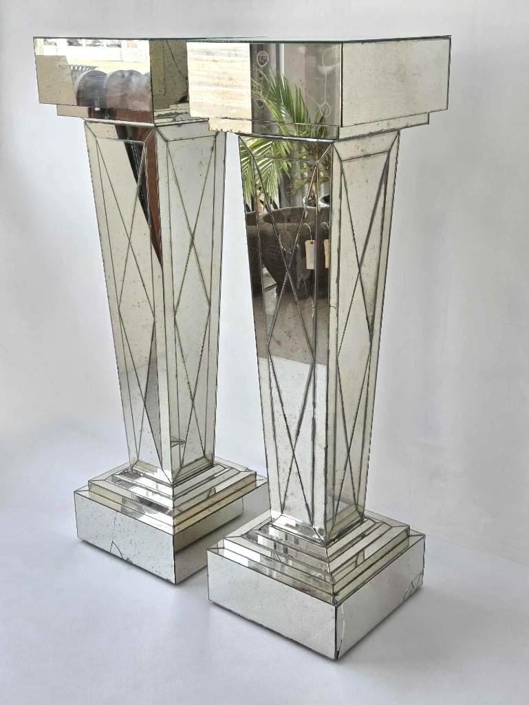 FINE PAIR OF VINTAGE VENFIELD NYC MIRRORED PEDESTAL COLUMNS: ***Tapered antiqued mirror pedestals with geometric etched panels and stepped bases by Venfield NYC. Approximate Dimensions: 47.5"h x 14"w x 14"d Artist or Maker: Venfield NYC Provenance: 