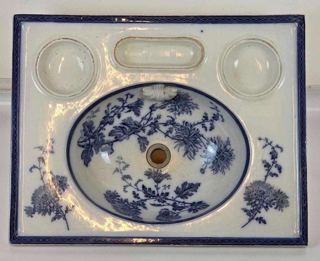 ANTIQUE ENGLISH BLUE AND WHITE TRANSFER-PRINTED PORCELAIN SINK BWM CAULDON: English blue and white transfer-printed porcelain wash sink with floral decoration and integral basin. English (impressed eagle/crest and registry marks to underside) Approximate Dimensions: 11" H