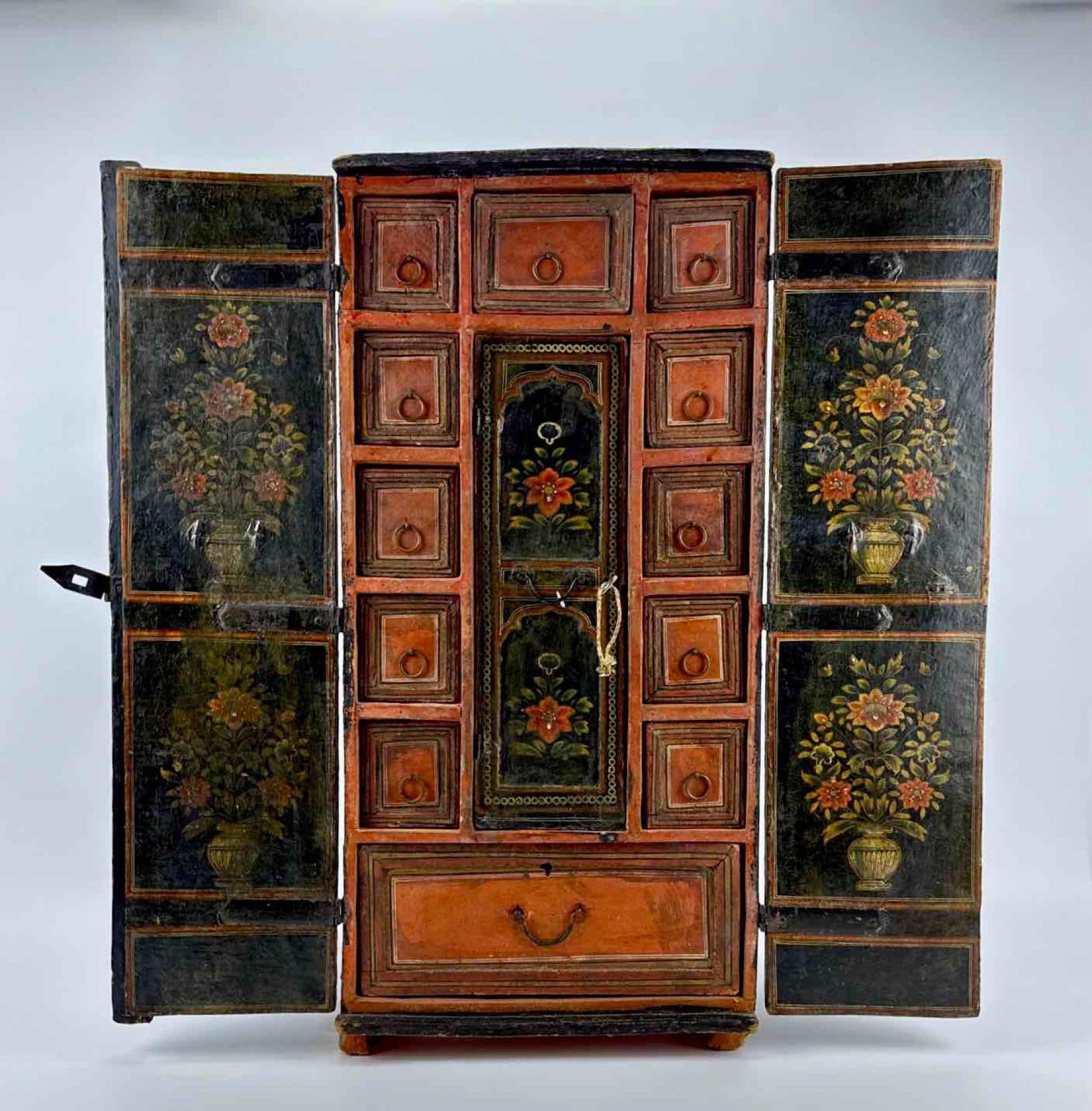 POLYCHROME PAINT-DECORATED TABLE CABINET, MUGHAL-STYLE FLORAL ARCH PANELS, FITTED DRAWER INTERIOR: a polychrome paint-decorated table cabinet with a fitted drawer interior. Approximate Dimensions: 28.25” H x 13.5” W x 6.5” D Artist or Maker: Unsigned Provenance: From a New York Co