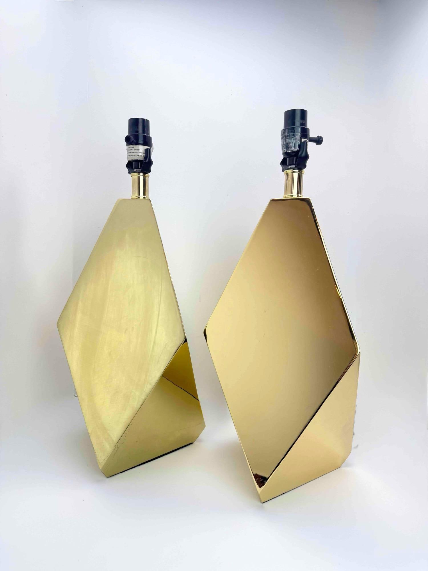 PAIR OF POLISHED BRASS GEOMETRIC TABLE LAMPS: A pair of mid-century modern angular faceted polished brass table lamps. Approximate Dimensions: 20.5” H x 8.5” W Artist or Maker: Unknown Provenance: A New York Collector Notes: