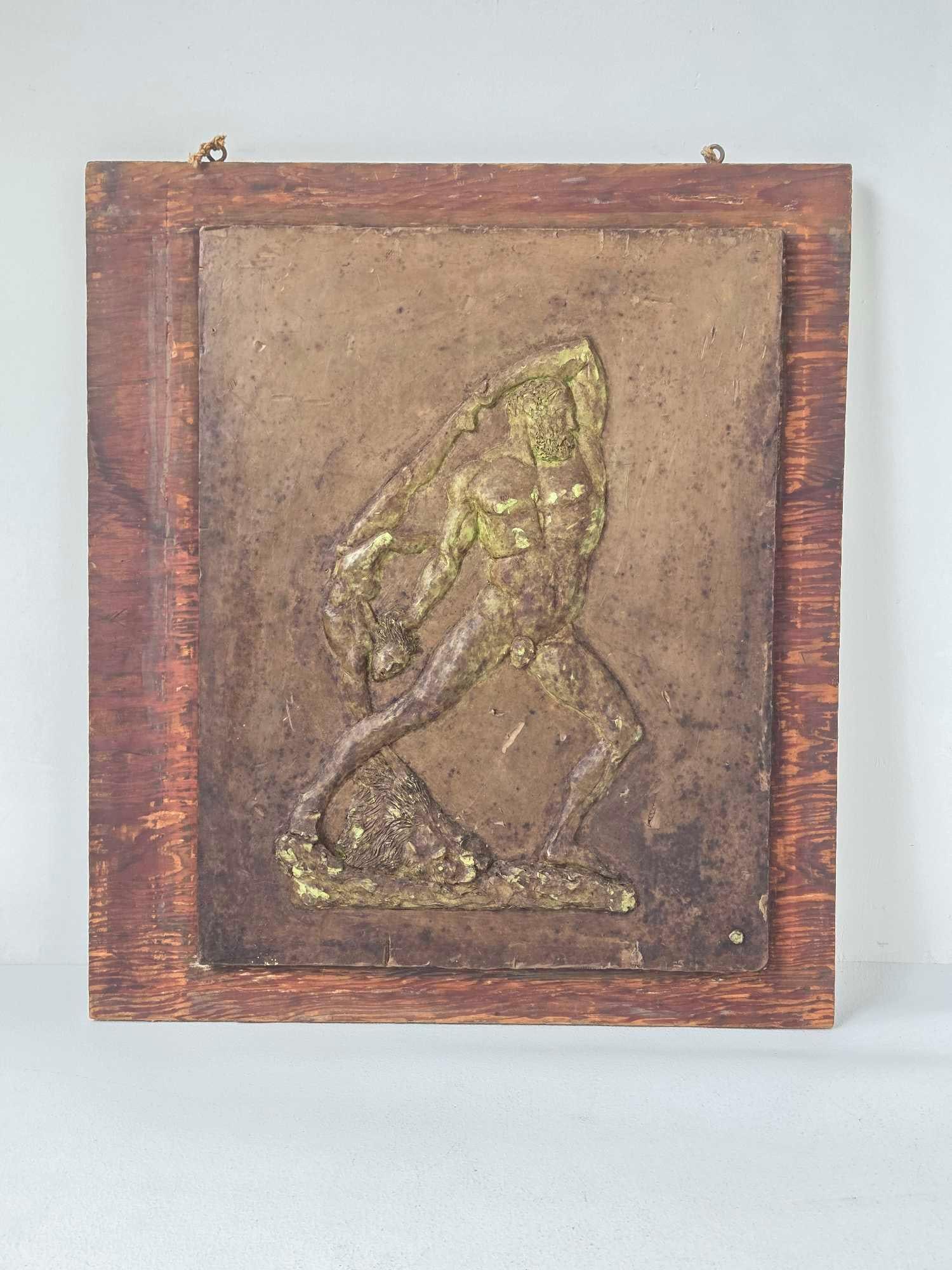 1959 PLASTICINE RELIEF "HERCULES" FRAMED: Sculpted plasticine relief panel of Hercules with lion skin in gilt finish, dated 1959, mounted in wood frame Approximate Dimensions: 20.5" x 16"; frame 24" x 21" Artist or Maker: Unkn