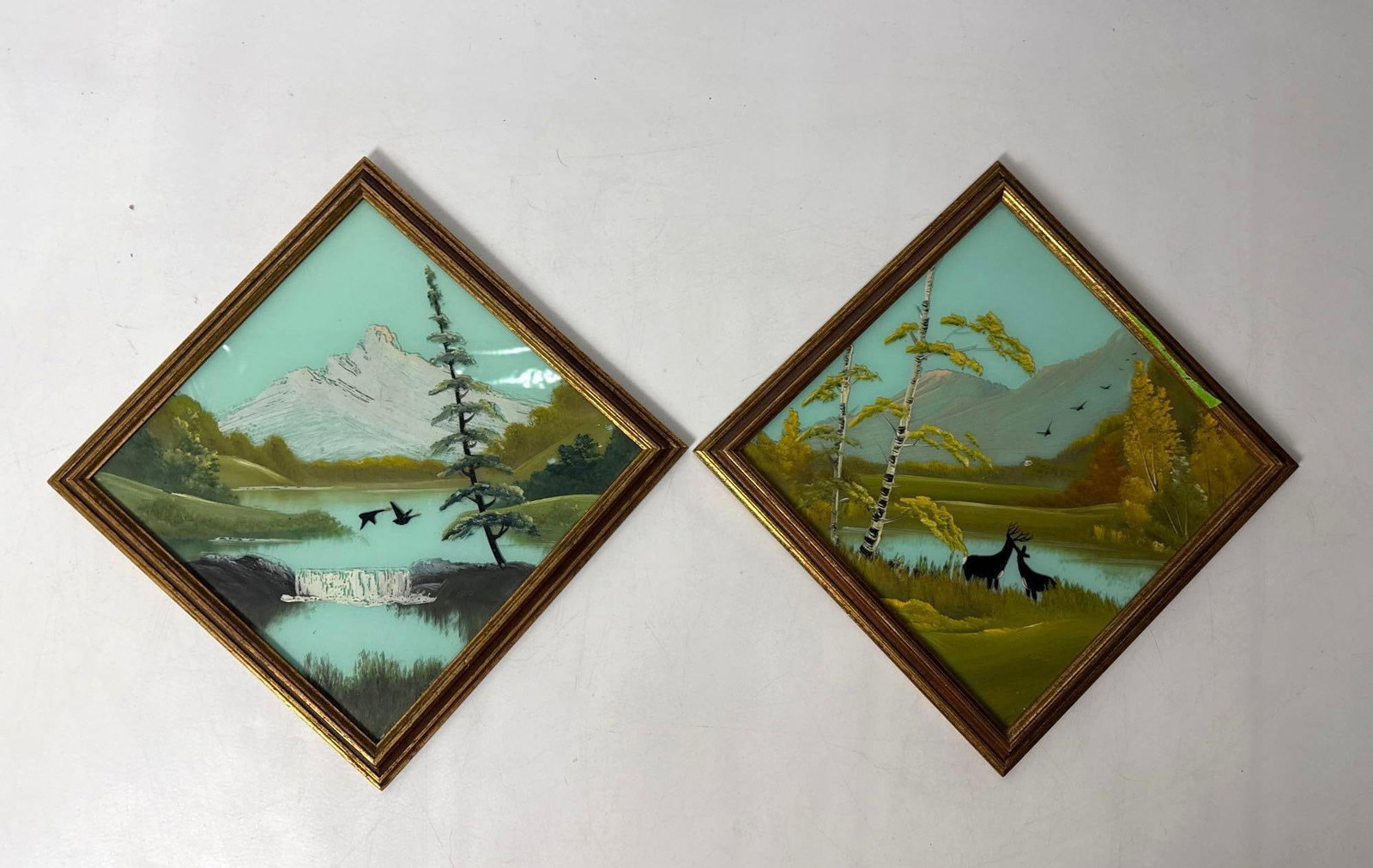 TWO FOLK ART REVERSE PAINTED GLASS LANDSCAPES: group of three diamond-hung reverse painted glass landscape scenes Approximate Dimensions: : 13.5” x 13.5 overall Artist or Maker: Unknown; folk art Provenance:A New York Gallerist and Collector