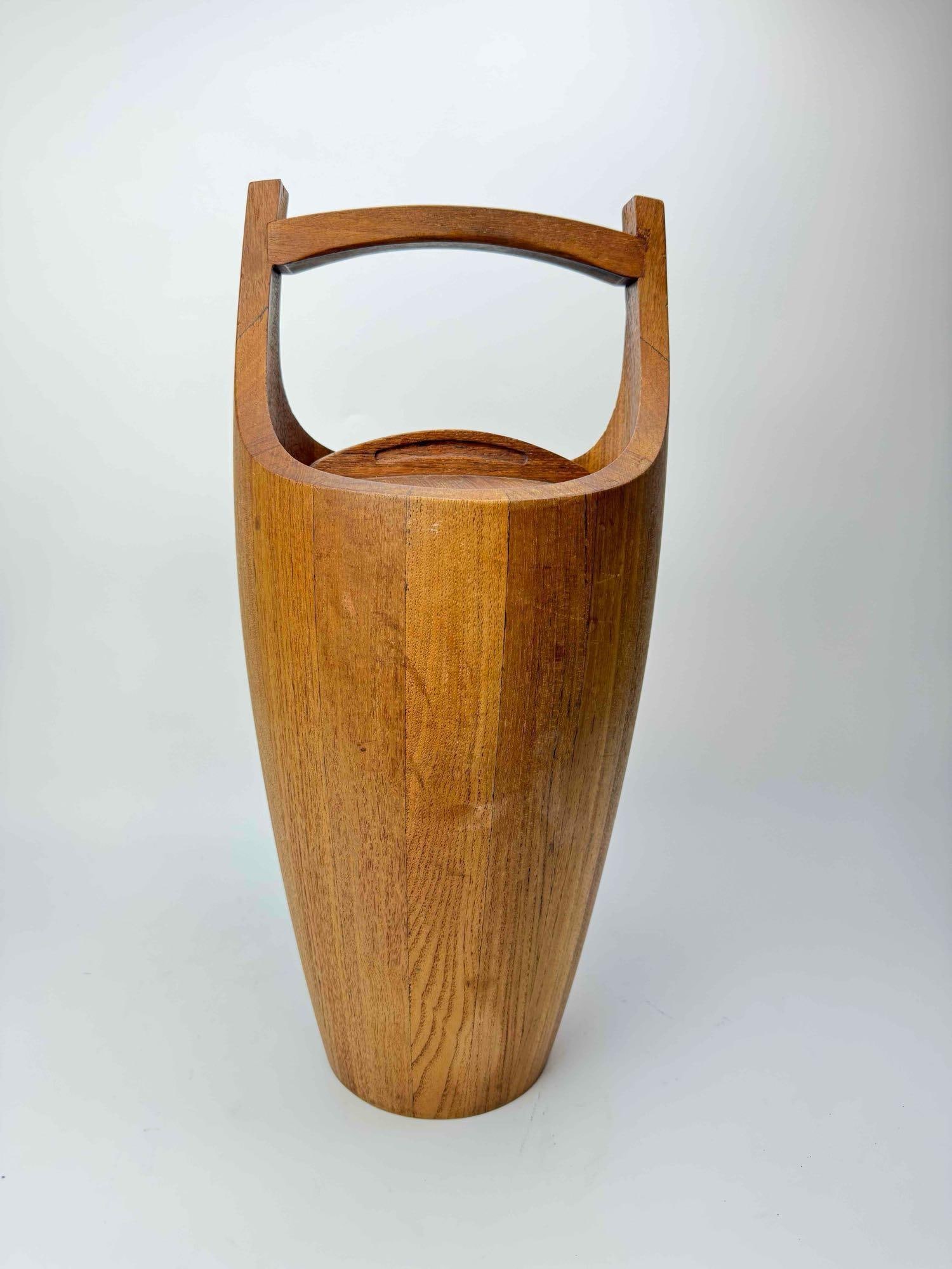 LARGE DANSK DANISH MODERN STAVED TEAK ICE BUCKET / WINE COOLER: Large sculptural Danish Modern staved teak ice bucket / wine cooler of tapering amphora form, with a shaped arched carry handle and raised on a turned circular foot Approximate Dimensions: 24"H