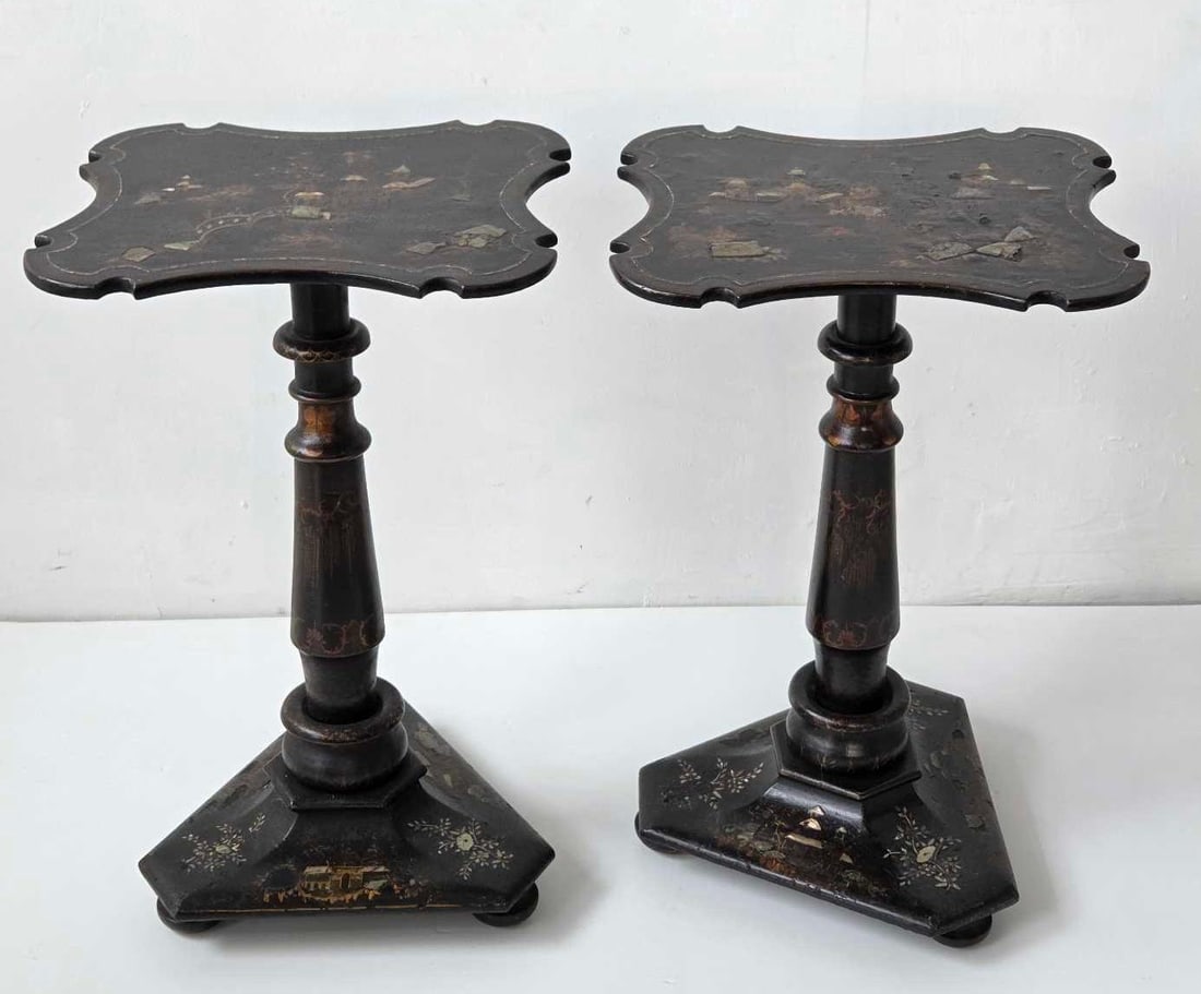 PAIR OF ANTIQUE PAPIER MACHE MOTHER OF PEARL INLAID DECORATED PEDESTAL TABLES: A pair of Victorian papier mché pedestal tables, each with a shaped cartouche top inlaid with mother of pearl and gilt painted decoration on a black lacquer ground, on a turned column and triform