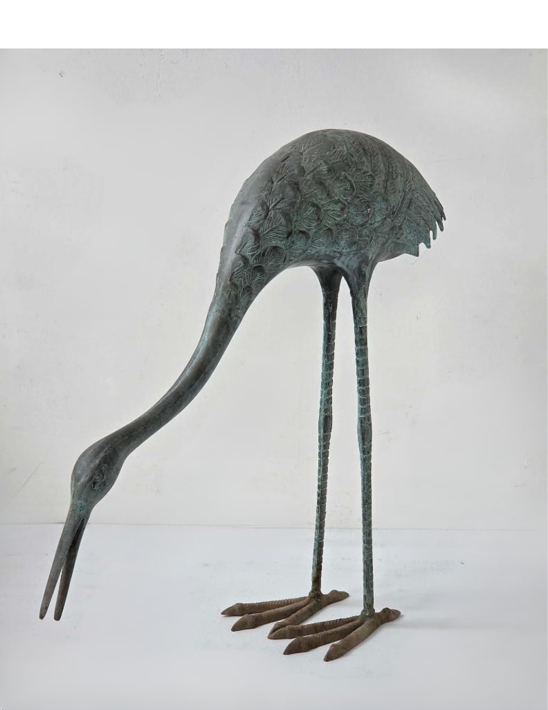 FIGURAL BRONZE FORAGING CRANE: A large figural bronze crane modeled foraging with its head lowered and beak to the ground, on long articulated legs and splayed feet, in a green verdigris patina Approximate Dimensions: 23.5" H x