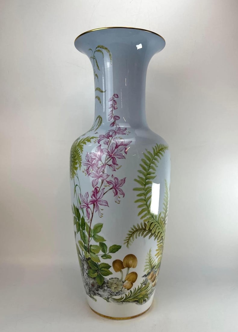 AK KAISER WEST GERMANY "FLORA LIE" PORCELAIN VASE BY FÜTTERER: A large, flared German porcelain vase with botanical wildflowers, mushrooms, and gilt rim accents. Approximate Dimensions: 26.5" H x 10.5” Dia Maker: AK Kaiser Provenance: A New York Collect
