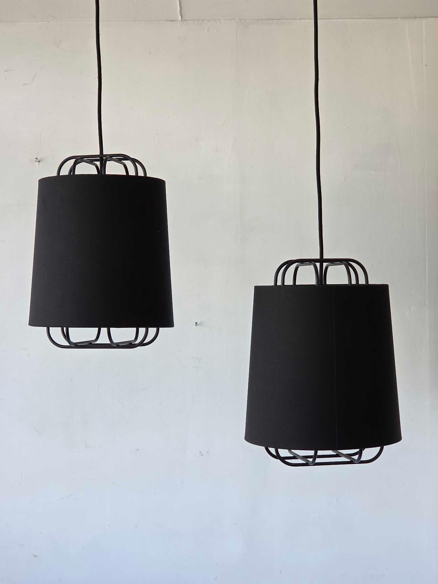 PAIR OF NUD BLACK CAGED PENDANT LIGHTS WITH LINEN DRUM SHADES: pair of powder coated wire cage pendant lights with black linen drum shades and black braided textile cords Approximate Dimensions Fixture Only: 15.5"H x 11.25"Dia Artist or Maker: NUD Provena