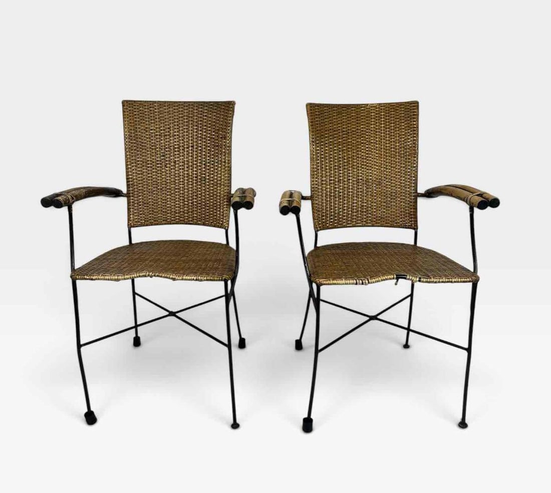 PAIR MID CENTURY WOVEN RATTAN AND BLACK IRON ARMCHAIRS WITH BAMBOO ARMS: pair of mid century armchairs with woven rattan seats and backs, bamboo wrapped arms and slender black iron rod frames Approximate Dimensions: 22" x 18" x 36" Artist or Maker: Unknown. Pro