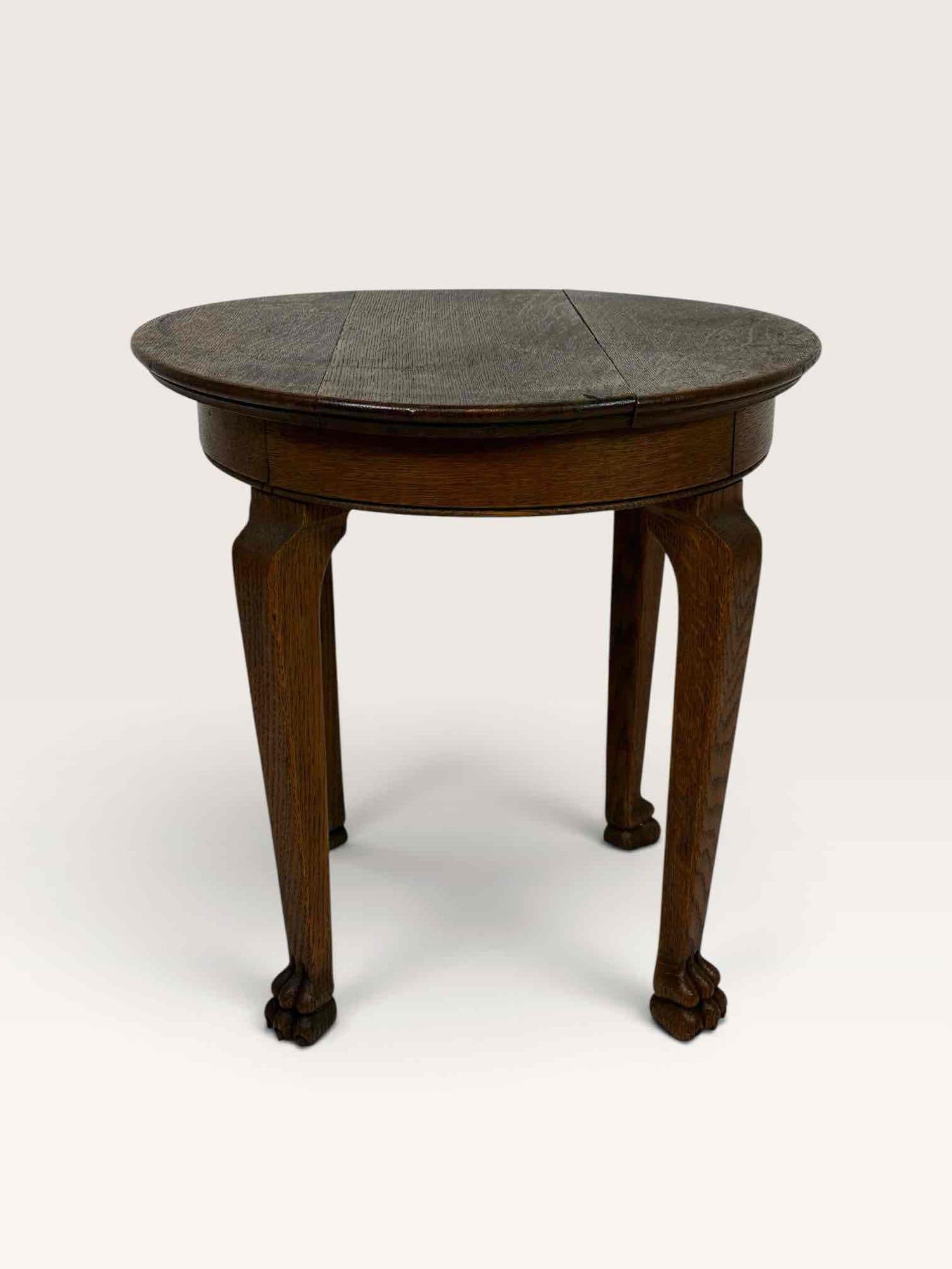 ANTIQUE QUARTERSAWN OAK ROUND SIDE TABLE WITH CABRIOLE LEGS AND CARVED PAW FEET: round quartersawn oak side table on three cabriole legs with carved paw feet, one top board detached and loose Approximate Dimensions: 18"Dia x 18"H Artist or Maker: Unknown. Provenance: From 
