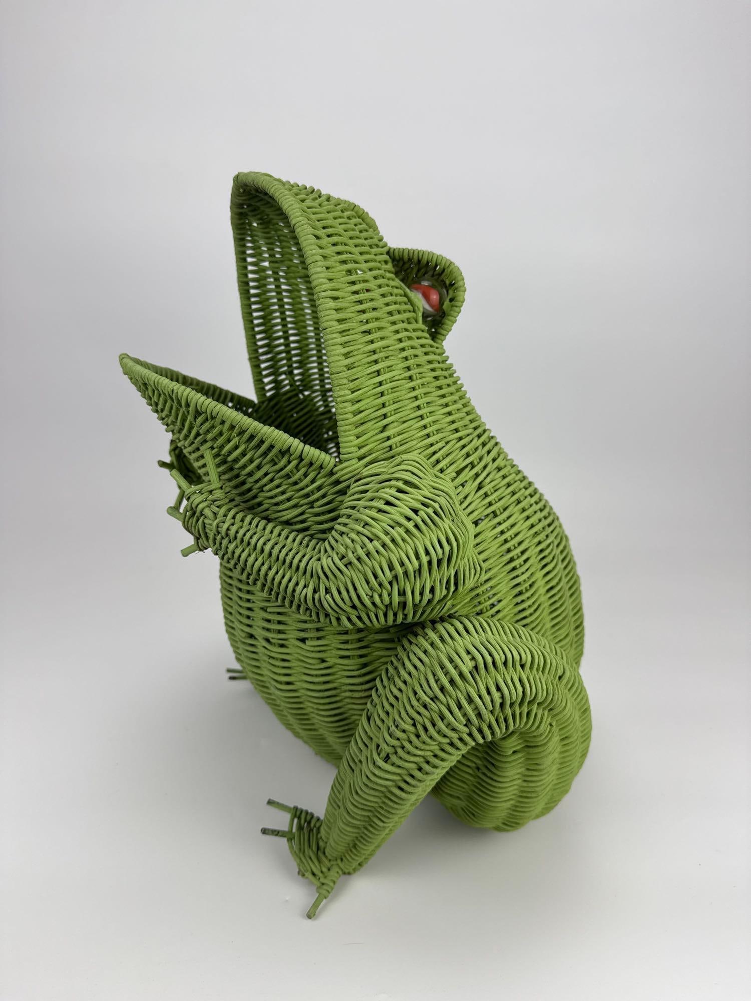 VINTAGE WOVEN WICKER FIGURAL FROG BASKET VASE: Woven wicker basket in the form of a seated frog Approximate Dimensions: 16"W x 16.5"H x 14"D Artist or Maker: Unknown Provenance: From a New York Collector Notes: Although care is taken t