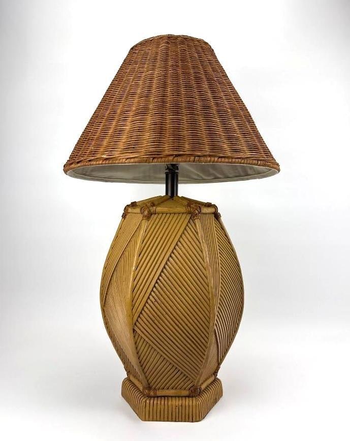 COASTAL SPLIT REED AND RATTAN TABLE LAMP WITH WICKER SHADE: Table lamp with an ovoid body wrapped in diagonally laid split reed over an octagonal reeded plinth, fitted with a conforming woven wicker coolie shade Approximate Dimensions: 21.5" H X 11" Di