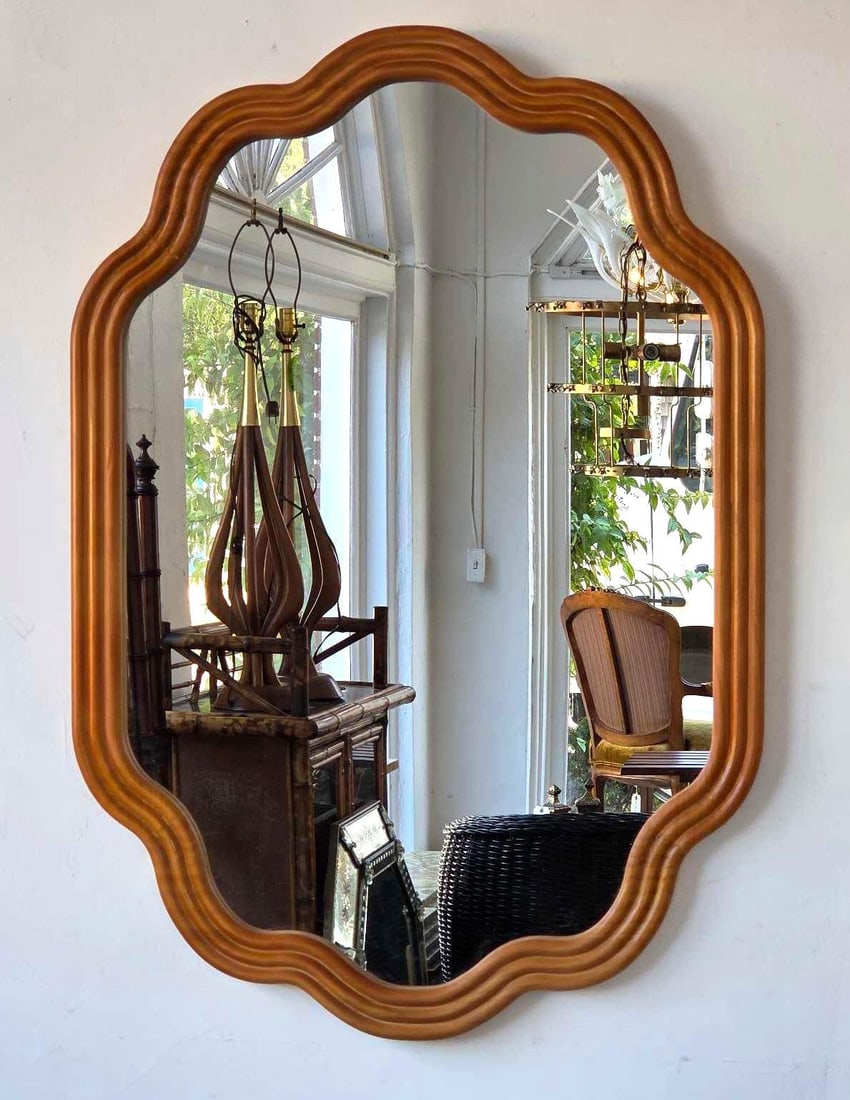 VINTAGE SCALLOPED SHAPED WOOD FRAME WALL MIRROR: Shaped wall mirror, scalloped serpentine outline, moulded and reeded wood frame in a honey finish. Approximate Dimensions: 34.5" H x 24" W Artist or Maker: Unknown Provenance: A New York Colle