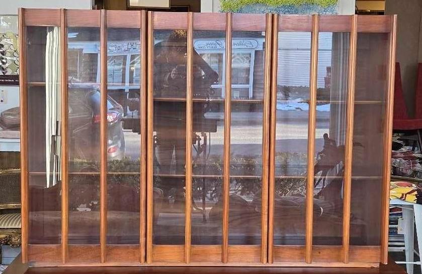 MID CENTURY WALNUT HUTCH DISPLAY CABINET WITH GLASS DOORS: A walnut wood storage unit featuring a glass-front display hutch with vertical wooden slats. Approximate Dimensions: 73"h x 65.75"w x 20"d Artist or Maker: Unknown Provenance: From a New Y