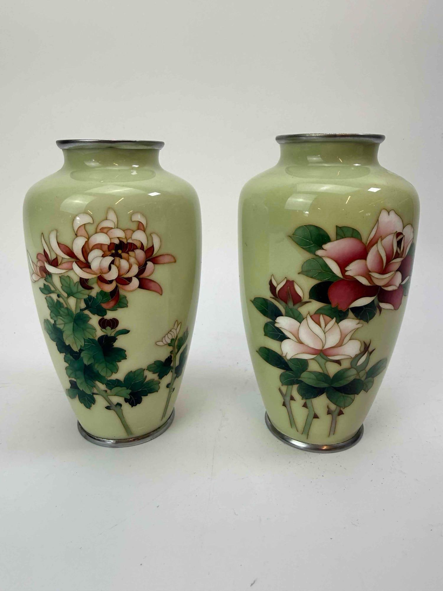 PAIR OF JAPANESE CLOISONNE ENAMEL VASES WITH PEONIES MARKED: Pair of cloisonne enamel vases of ovoid form, each decorated with pink peonies and blossoming branches on a pale celadon green ground, with silvered metal rims and feet Approximate Dimensions: 5.75