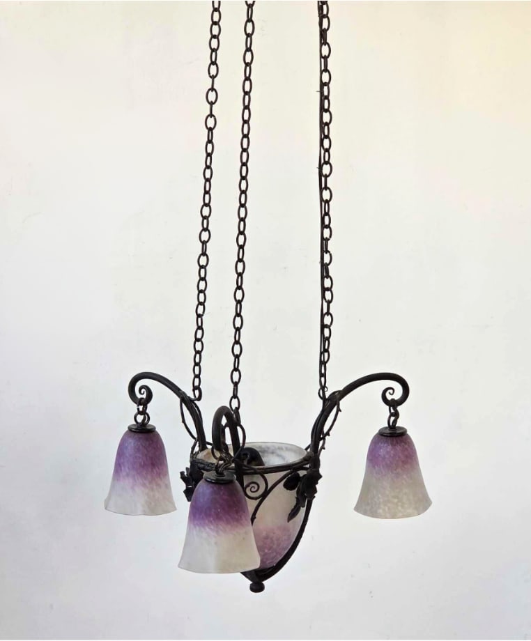 VINTAGE ART DECO WROUGHT IRON AND PATE DE VERRE FOUR LIGHT CHANDELIER: Art Deco chandelier, wrought iron frame with scrolled arms and applied iron foliage, three mottled purple and white art glass tulip shades around a central shade, on chain suspension Approximate Dimen