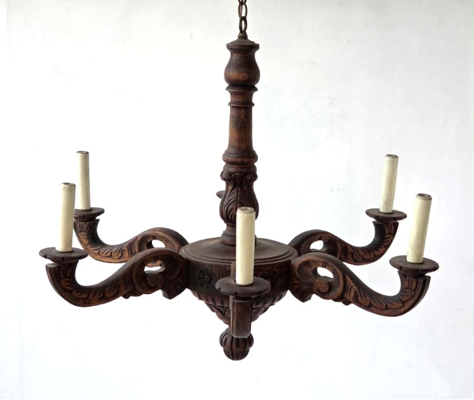 VINTAGE CARVED WOOD SIX ARM CHANDELIER: Six arm chandelier with scrolled acanthus carved arms issuing from a turned baluster standard over a carved drop, with moulded bobeches and candle sleeves, suspended on a chain Approximate Dimensions: