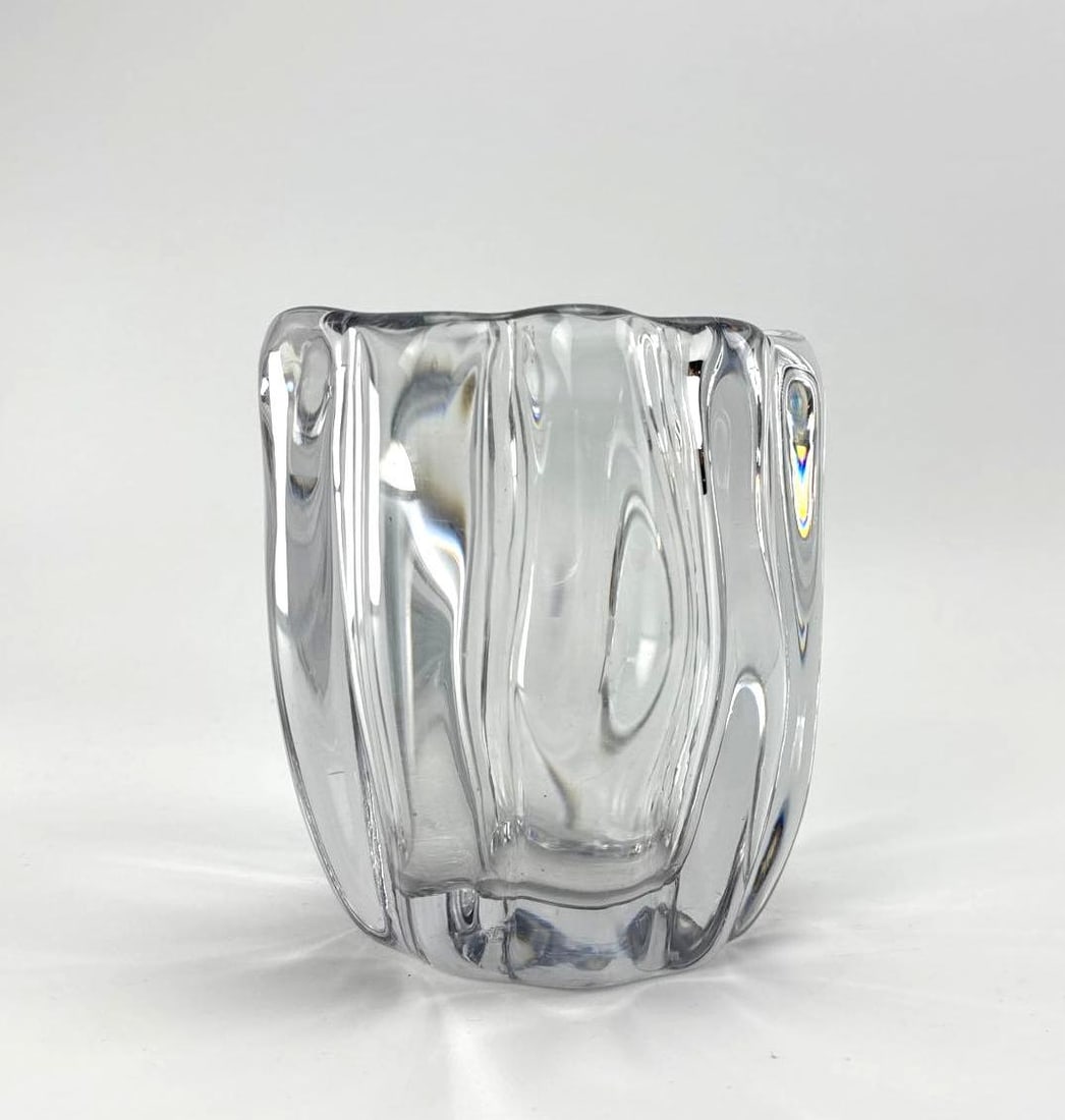 TAPIO WIRKKALA MOULDED CLEAR CRYSTAL VASE WITH UNDULATING RIBBED BODY SIGNED: Heavy clear crystal vase of squared form with thick undulating vertical ribs and a polished rim. Signed on bottom Approximate Dimensions: 6" H x 5.25" W Artist or Maker: Tapio Wirkkala for Iit