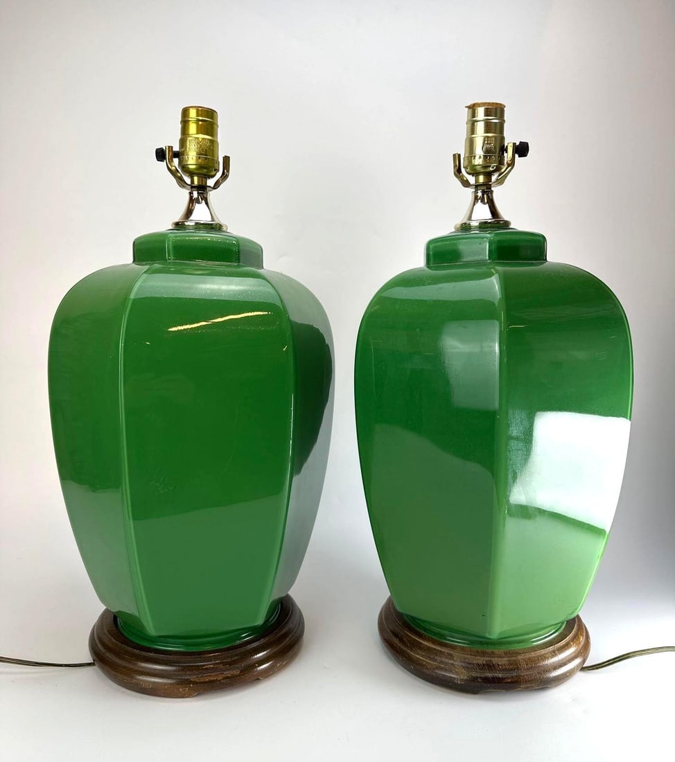 PAIR OF APPLE GREEN REVERSE-PAINTED GLASS BALUSTER TABLE LAMPS ON WOOD BASES: Pair of table lamps with faceted baluster bodies in reverse-painted glass finished in a glossy apple green, with brass caps and sockets, raised on turned wood bases Approximate Dimensions: 10" Dia