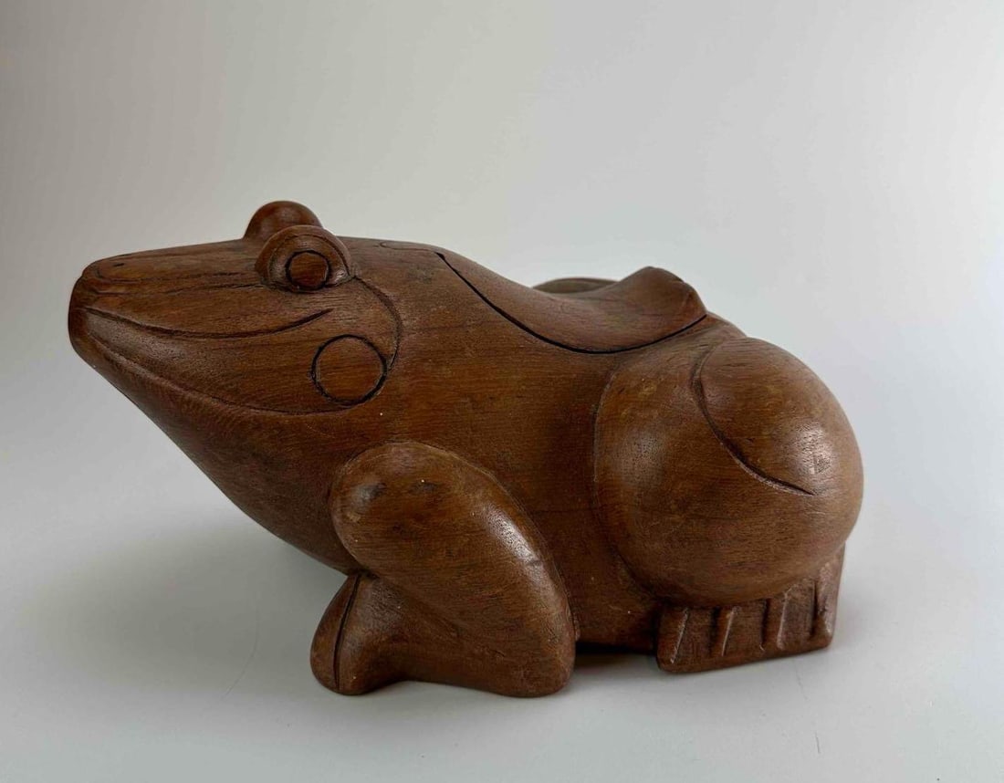 HAND CARVED NATURAL WOOD FROG: Hand carved wood frog in a crouching pose with smoothly finished body, carved eyes and tucked limbs, in pale natural timber Approximate Dimensions: 12" x 7" x 6" Artist or Maker: Unknown Provenance: