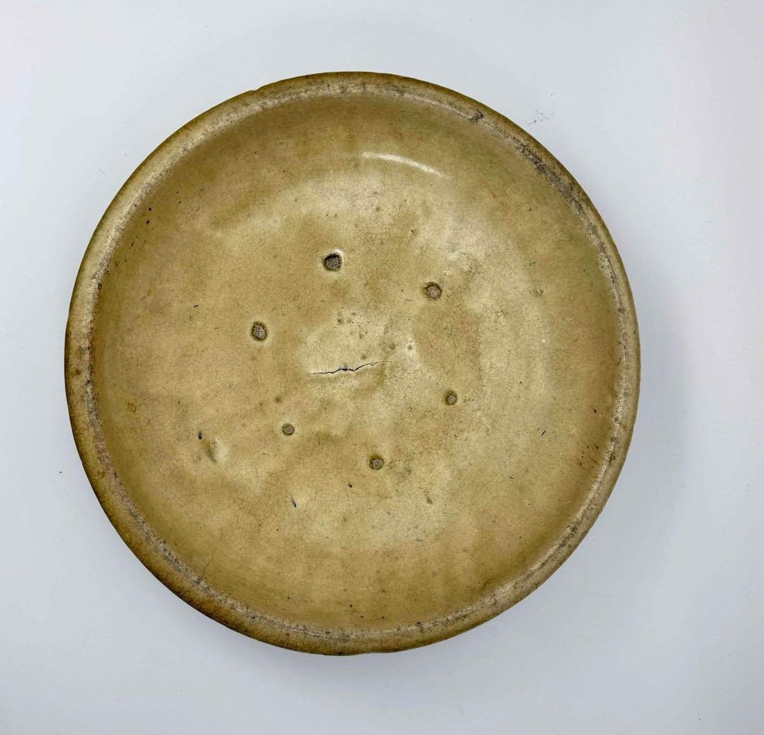GLAZED CERAMIC SHALLOW DISH WITH OLIVE AND CREAM SPECKLED GLAZE: Shallow circular ceramic dish with a slightly everted rim, covered in a mottled olive and cream glaze with scattered iron spotting Approximate Dimensions: 3" H x 15" Dia Artist or Maker: Unkno
