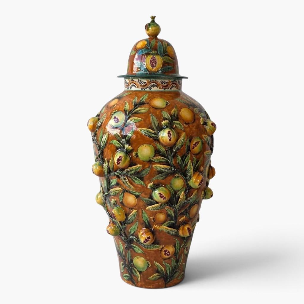 LARGE SANTA ROSA GUANAJUATO MEXICAN MAJOLICA POMEGRANATE COVERED URN: Large majolica glazed pottery covered urn, the ovoid body applied in high relief with pomegranates, fruit and foliage on an ochre ground, the domed cover with a pomegranate finial over a scrolled bord