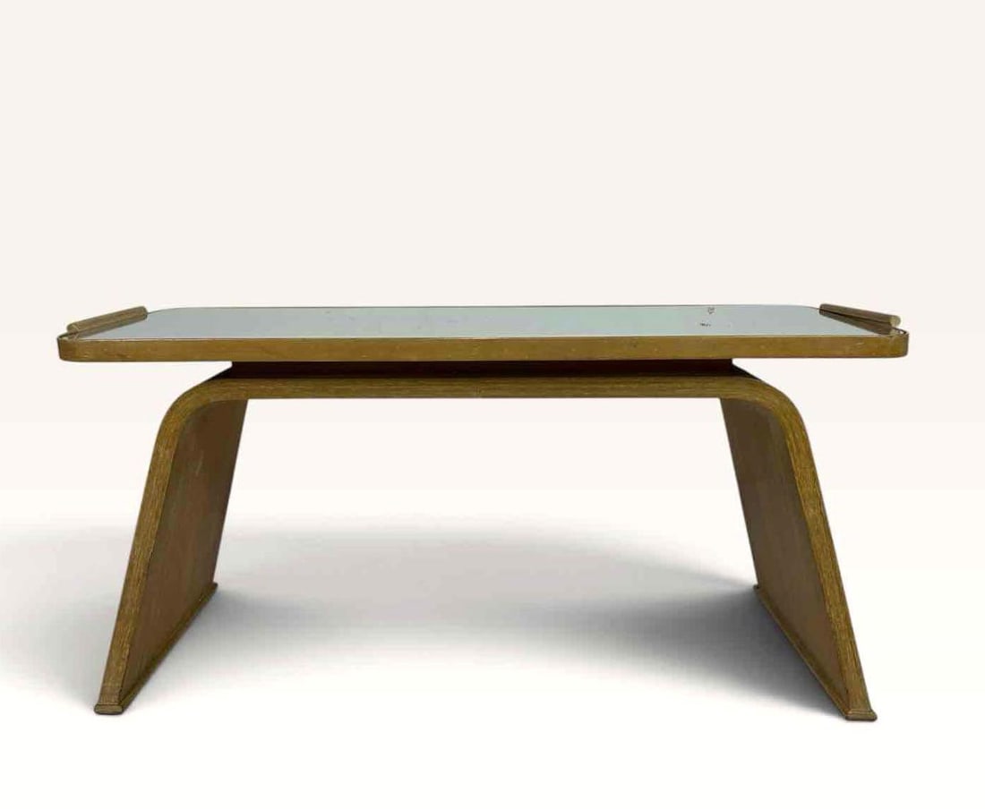 MIDCENTURY MODERN BENT PLYWOOD AND MIRROR TOP LOW TABLE WITH SCULPTURAL SLED LEGS: Low rectangular table with a mirrored top in a moulded frame. note repairs to handles. Approximate Dimensions: 22 "H x 46 "W x 19 "D Artist or Maker: Unknown Provenance: From a New York Co