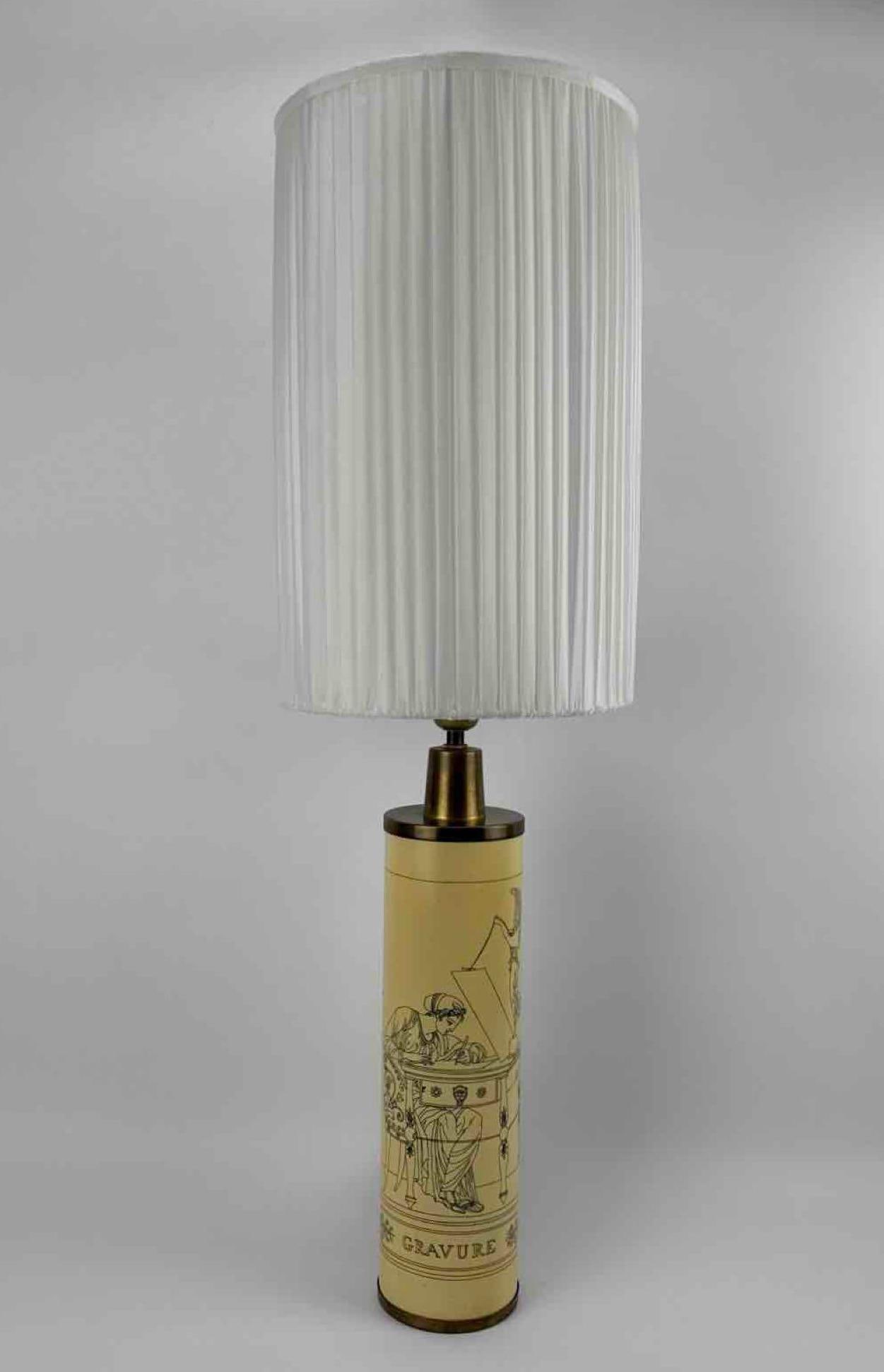 FORNASETTI MILANO "GRAVURE" TRANSFER PRINTED CYLINDER TABLE LAMP WITH PLEATED SILK SHADE: Cylindrical transfer printed table lamp with brass mounts and pleated silk shade Approximate Dimensions: 18.5 "H x 4 "Dia, shade 16 "H x 10 "Dia Artist or Maker: Fornasetti, Milano, wi