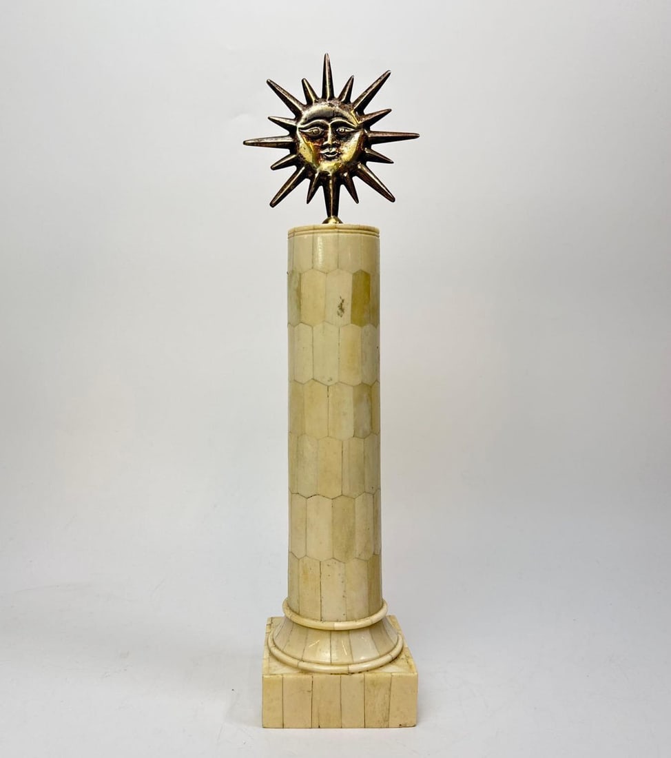 TESSELLATED BONE CLASSICAL COLUMN WITH BRASS SUNFACE FINIAL: Classical column form ornament veneered in tessellated bone tiles, ring turned capital and moulded socle over a stepped square plinth, surmounted by a removable pierced brass sunface finial on an iron