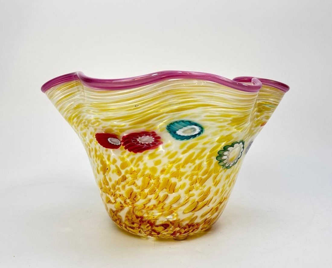 PAUL ALLEN COUNTS SIGNED STUDIO ART GLASS MILLEFIORI RUFFLED BOWL: Hand blown studio art glass bowl of flared ruffled form, mottled yellow and amber ground over white casing, applied millefiori canes in red, teal and green, cranberry rim wrap Approximate Dimensions: 