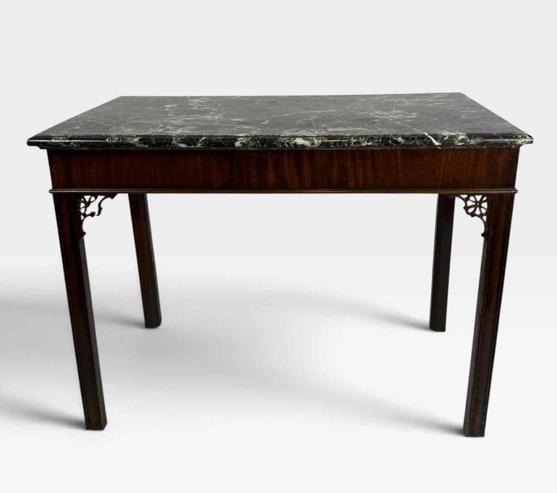 GEORGIAN MAHOGANY MARBLE-TOP TABLE WITH FRET BRACKETS: Georgian mahogany side or pier table, the variegated green and black marble top over a plain frieze, raised on straight molded legs with pierced fret corner brackets Approx. Dimensions: 42in W x 24in 