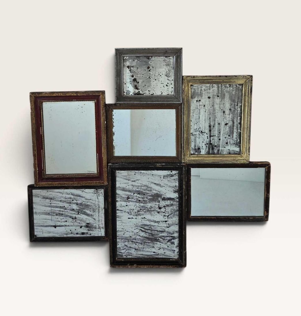 ANTIQUE MULTI-PANE DISTRESSED WALL MIRROR COLLAGE: An asymmetrical composition of seven interconnected rectangular framed mirrors in varying sizes with distressed antiqued glass. Approximate Dimensions: 42" L x 44" W Artist or Maker: Unknown P