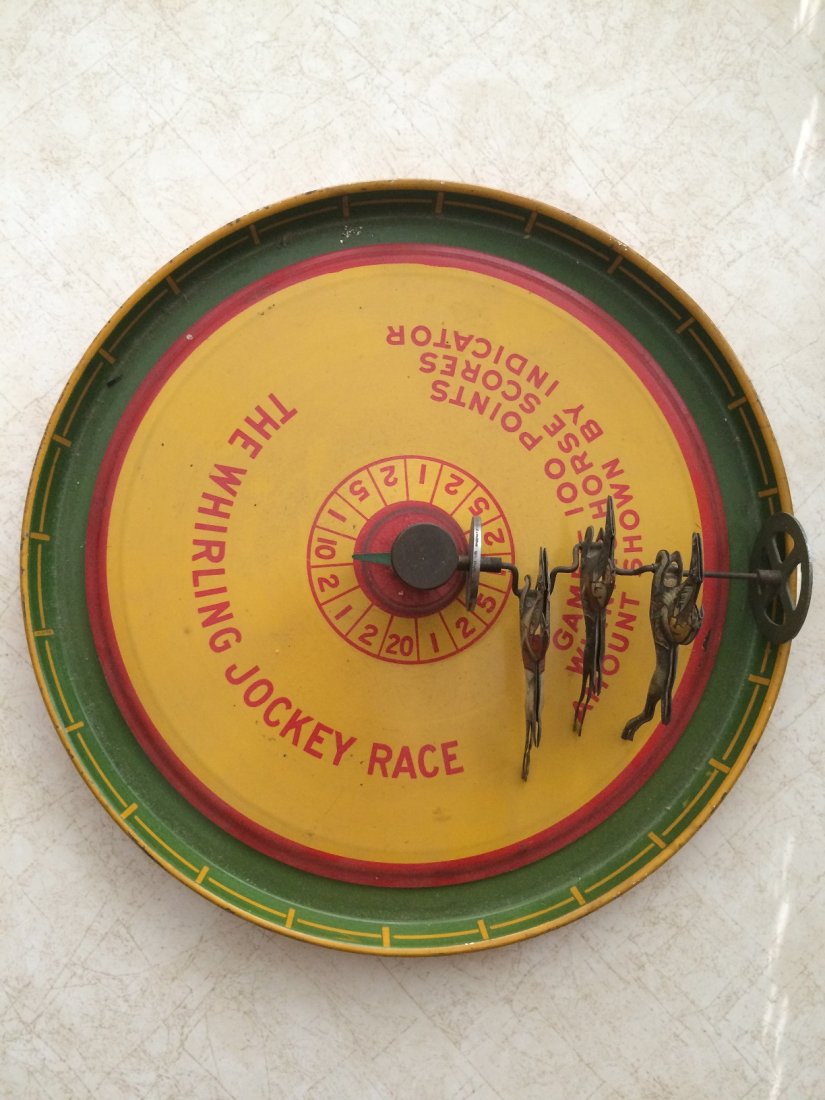 VINTAGE MCDOWELL MFG CO. TIN LITHO WHIRLING JOCKEY TOY: VINTAGE TIN LITHO WHIRLING JOCKEY TOY. MADE IN 1930"- 1940:S BY THE MCDOWELL MFG CO. THIS IS A SPINNING RACE HORSE TOY THAT MEASURES 10 INCHES IN DIAMETER AND IS IN VERY GOOD CONDITION . WE OFFER IN H