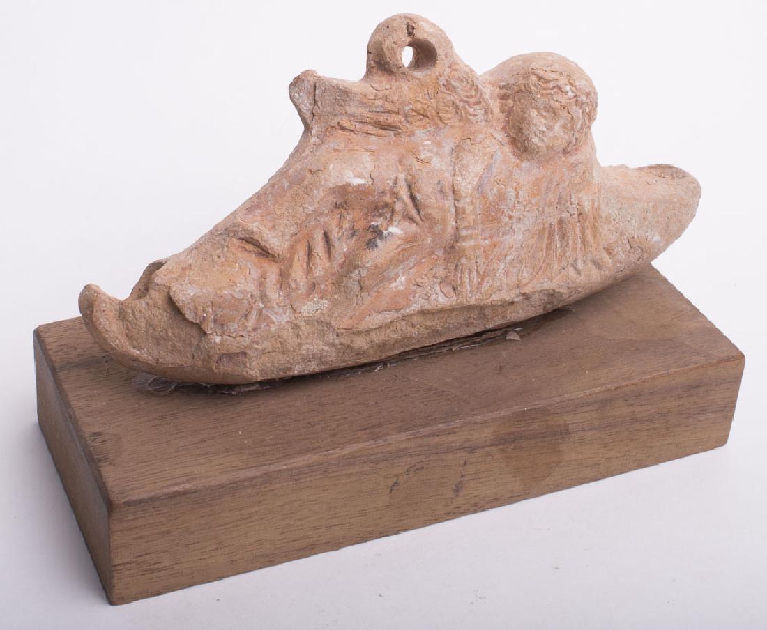 Ancient Hellenistic Terracotta Oil Lamp with Eros c.1st: Ancient Hellenistic Terracotta Oil Lamp with Eros c.1st century BC. Size 4 3/4 inches length. Rare Oil Lamp with reclining Eros with suspension loop. custom mounted. old chips and ware otherwise perfe