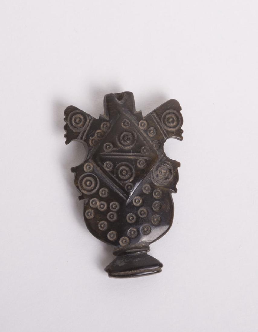 Ancient Byzantine black stone post c.7th century AD: Ancient Byzantine black stone post c.7th/9th century AD. Size of the figure 2 inches high. Fine carved black stone post with circle design and 2 animal heads on the side, a hole through the top probab