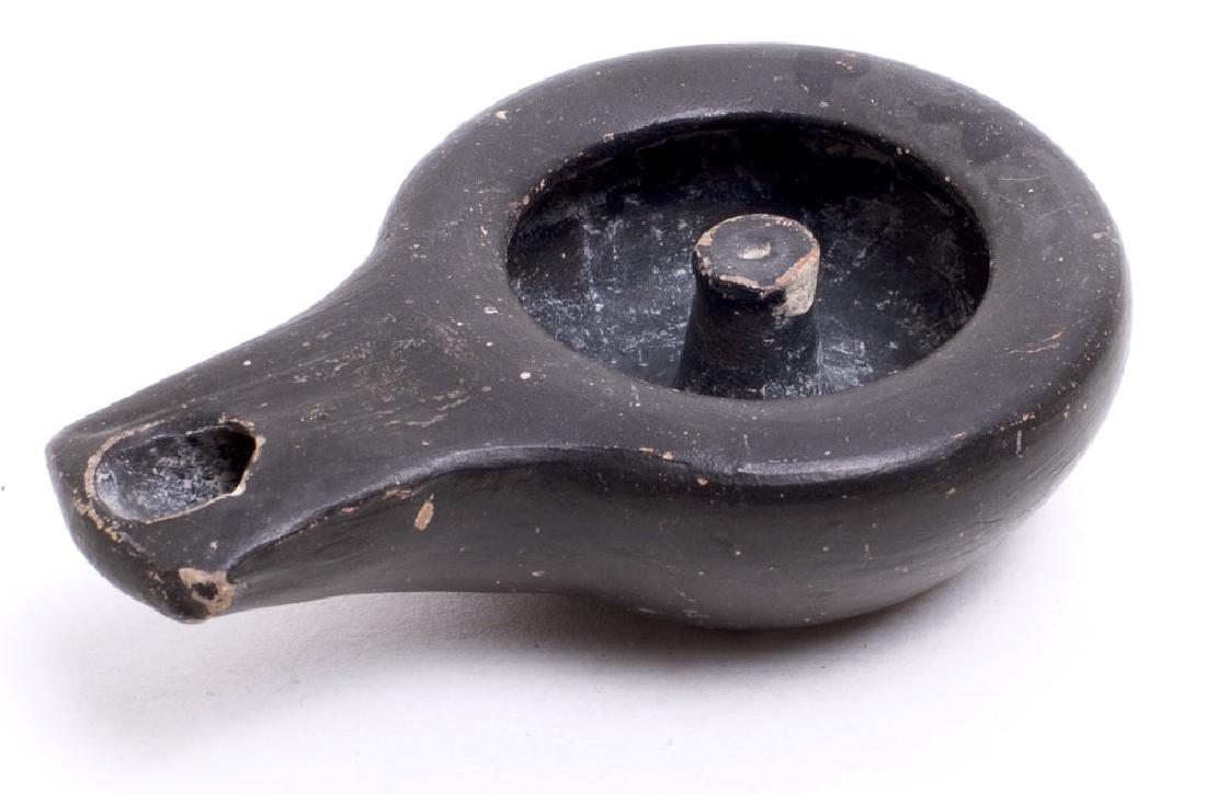 Ancient South Italian Apulian Pottery Oil Lamp c.4th ce: Ancient South Italian Apulian Pottery Oil Lamp c.4th century BC. Size 3 1/8 inches length. unusual black glazed pottery oil lamp. Condition: perfect. Provenance: from the estate of Robert Thompson of