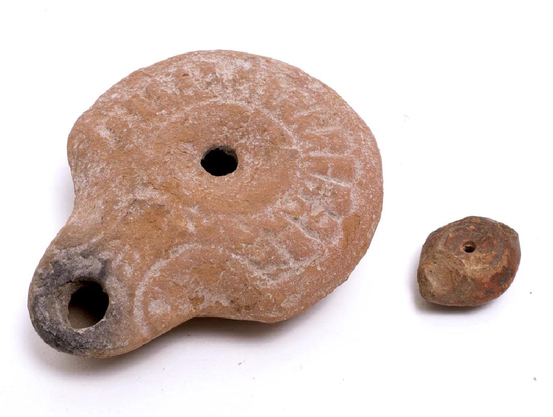 Lot of 2 Ancient Roman Egypt Terracotta Oil Lamps: Lot of 2 Ancient Roman Egypt Terracotta Oil Lamps c.2nd century AD. Size 2 7/8 and 1 inches length. A red terracotta oil lamp decorated on the obverse together with a miniature 1 inch terracotta oil l