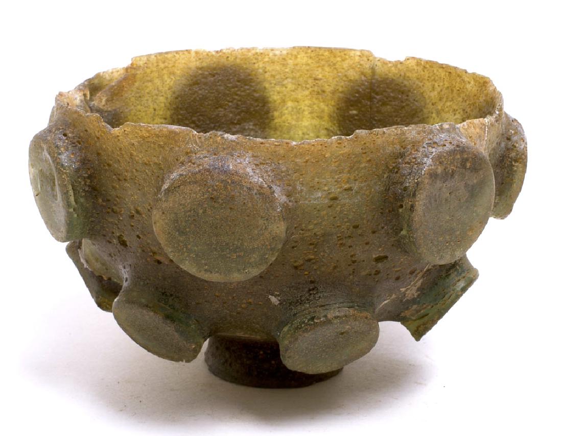 Ancient Sasanian Cut Glass Bowl c.5th century AD: Ancient Sasanian Cut Glass Bowl c.5th century AD. Size 4 1/8 inches diameter, 2 5/8 inches high. Rare Ancient Cut green glass bowl decorated with large circle medallions. condition: Repaired with Loos