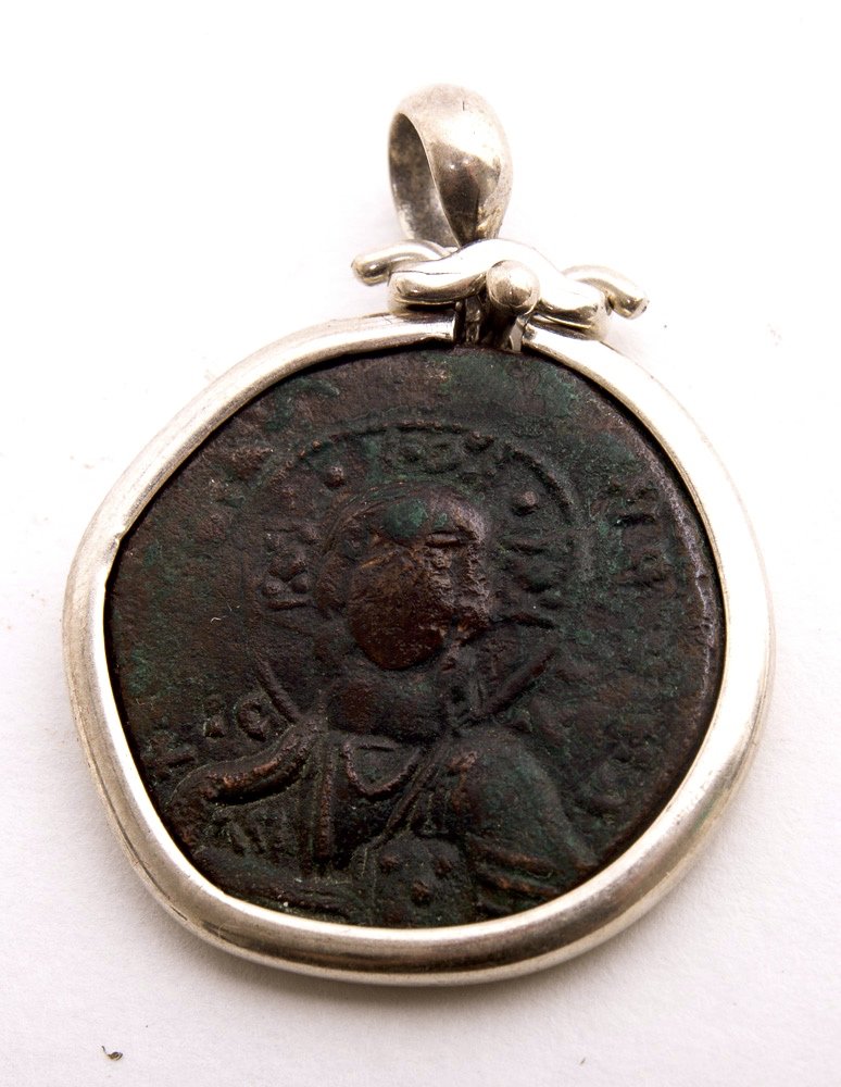 Ancient Byzantine Bronze coin With Christ set in Silver: Ancient Byzantine Bronze coin With Christ set in Silver Pendant c.10th century AD. Authentic Byzantine Empire Christ facing Bronze coin, Very Fine condition. The coin is authentic set in Modern Silver