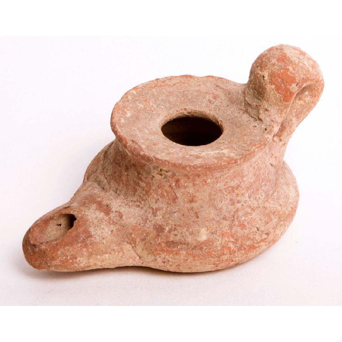 Ancient Islamic Pottery Oil Lamp c.8th century AD: Ancient Islamic Pottery Oil Lamp c.8th century AD. Size 3 1/2 inches Length. Early Islamic Pottery oil lamp with loop handle. Condition: minor chips otherwise perfect. Provenance: Ex The Time Machine 