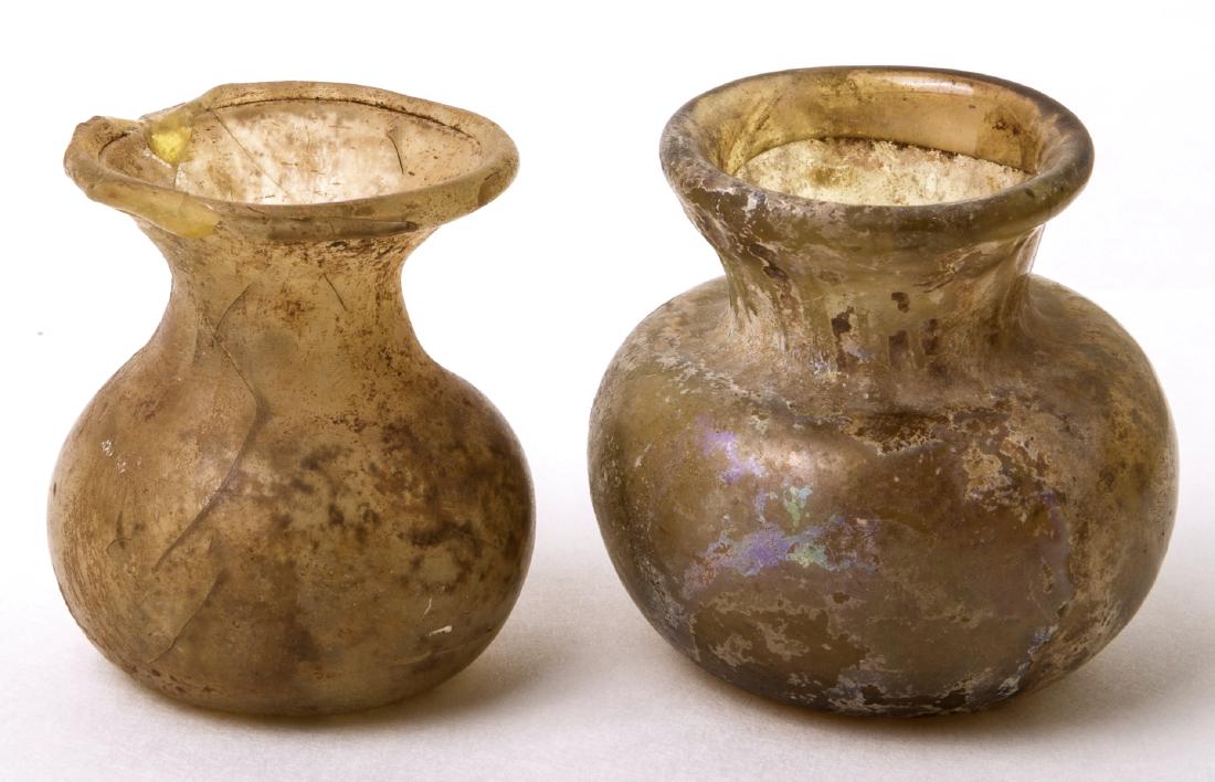 Lot of 2 Ancient Roman Glass Bottles c.2nd-3rd century: Lot of 2 Ancient Roman Glass Bottles c.2nd-3rd century AD. Size 2 inches high. Fine Blown glass bottles with iridescent patina. Intact. Nice iridescence. Condition: one is intact the second with chips