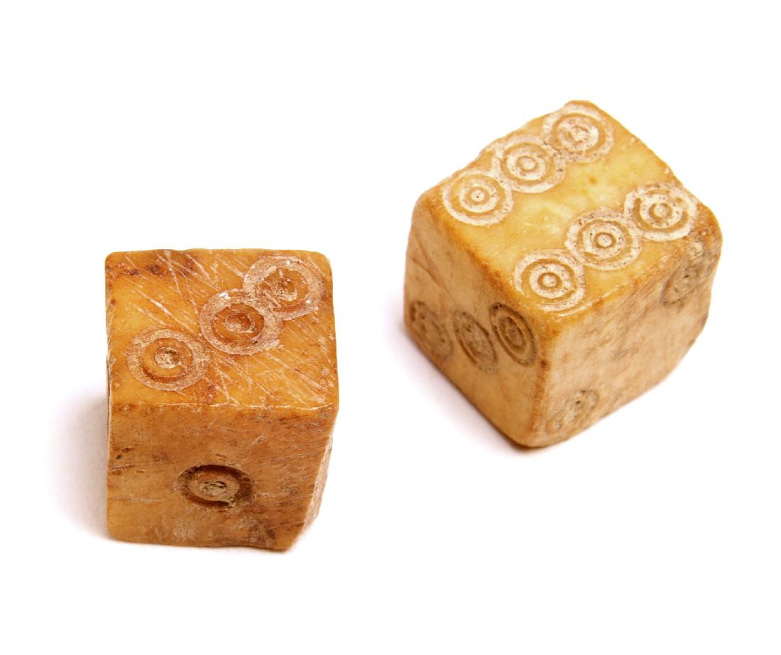 A Pair of Ancient Roman Carved Bone Dice, Circa 2nd: A Pair of Ancient Roman Carved Bone Dice, Circa 2nd-3rd century AD. Size 13 mm. A Matching pair of Roman Bone Dice, Rough fashioned cut gaming pieces, each face of the die with incised numbers. Aged d