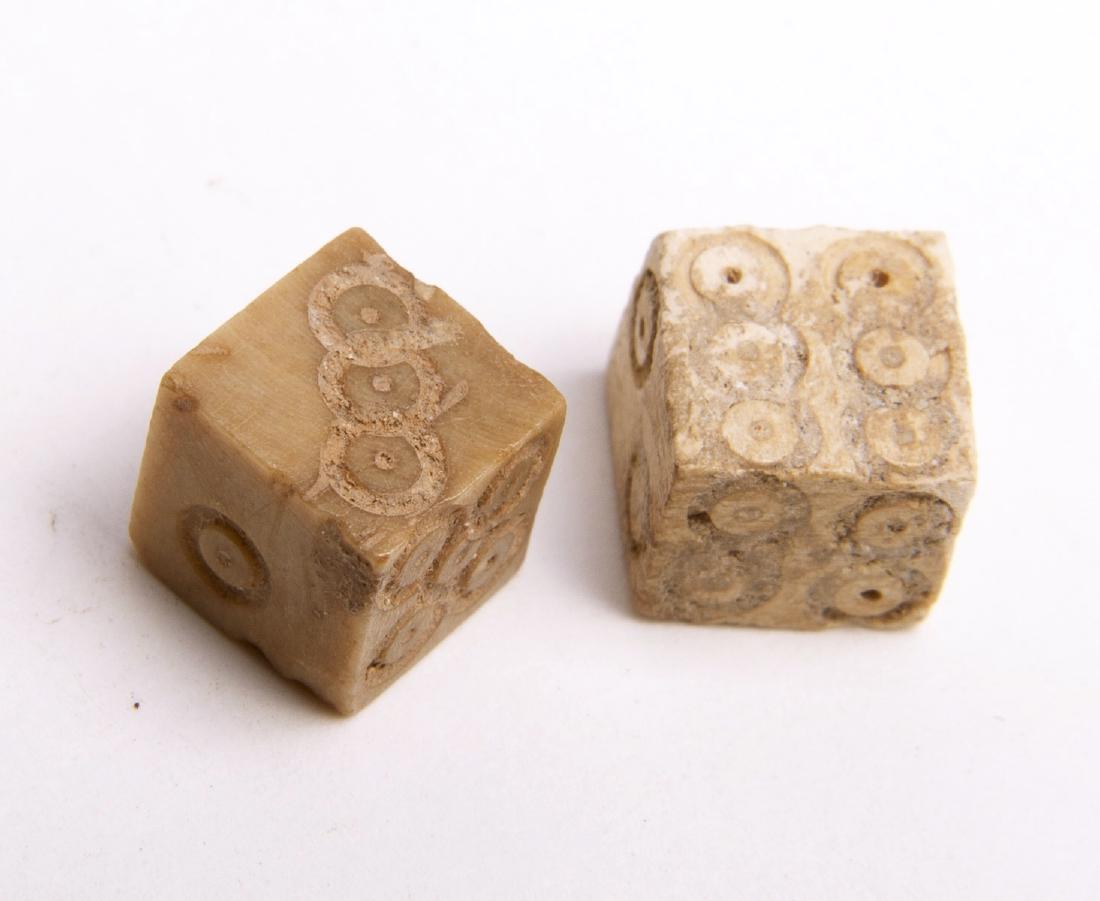 Ancient Roman Bone Carved Dice (2) Circa 2nd to 3rd Cen: Ancient Roman Bone Carved Dice (2) Circa 2nd to 3rd Century AD. Rough fashioned cut gaming pieces, each face of the die with incised numbers. Approx. 3/8 inch squares. Aged darkened surfaces.Provenanc