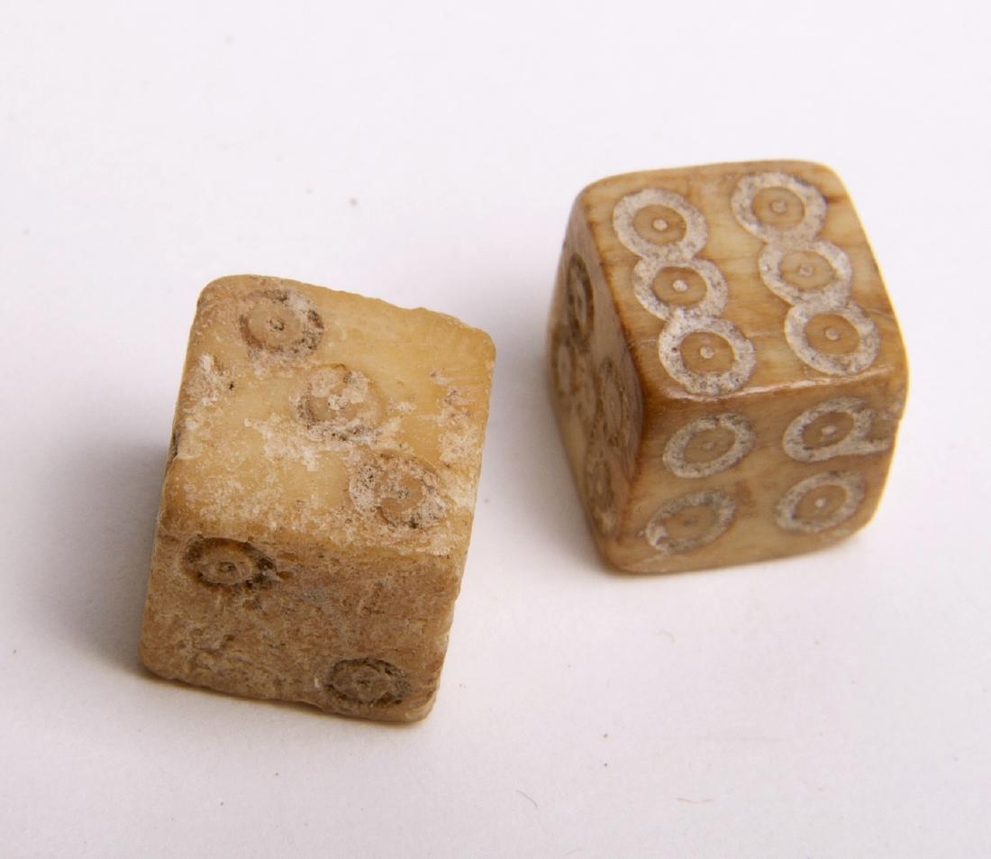 Ancient Roman Bone Carved Dice (2) Circa 2nd to 3rd Cen: Ancient Roman Bone Carved Dice (2) Circa 2nd to 3rd Century AD. Rough fashioned cut gaming pieces, each face of the die with incised numbers. Approx. 3/8 inch squares. Aged darkened surfaces.Provenanc