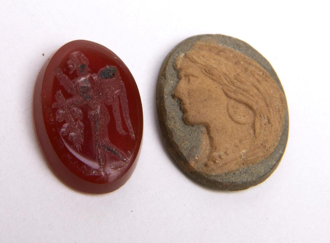 Ancient Roman Carnelian Intaglio c.2nd-3rd century AD.: Ancient Roman Carnelian Intaglio c.2nd-3rd century AD. Size 13 x 9 mm. A red Carnelian Intaglio carved with Nike facing left. together with later period Cameo Intaglio. with facing woman facing left s