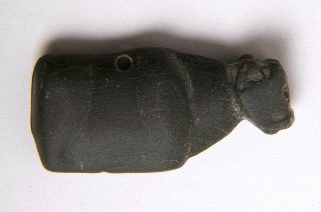 Mesopotamian Amulet of Bull Reclining, Jemdet Nasr: Ancient Mesopotamian Amulet of Bull Reclining, Jemdet Nasr Period, 3300-2900 BC. Size 39 x 19 mm. Carved hard stone reclining Bull with hole through for suspension. Intact. Provenance: Ex Private New 