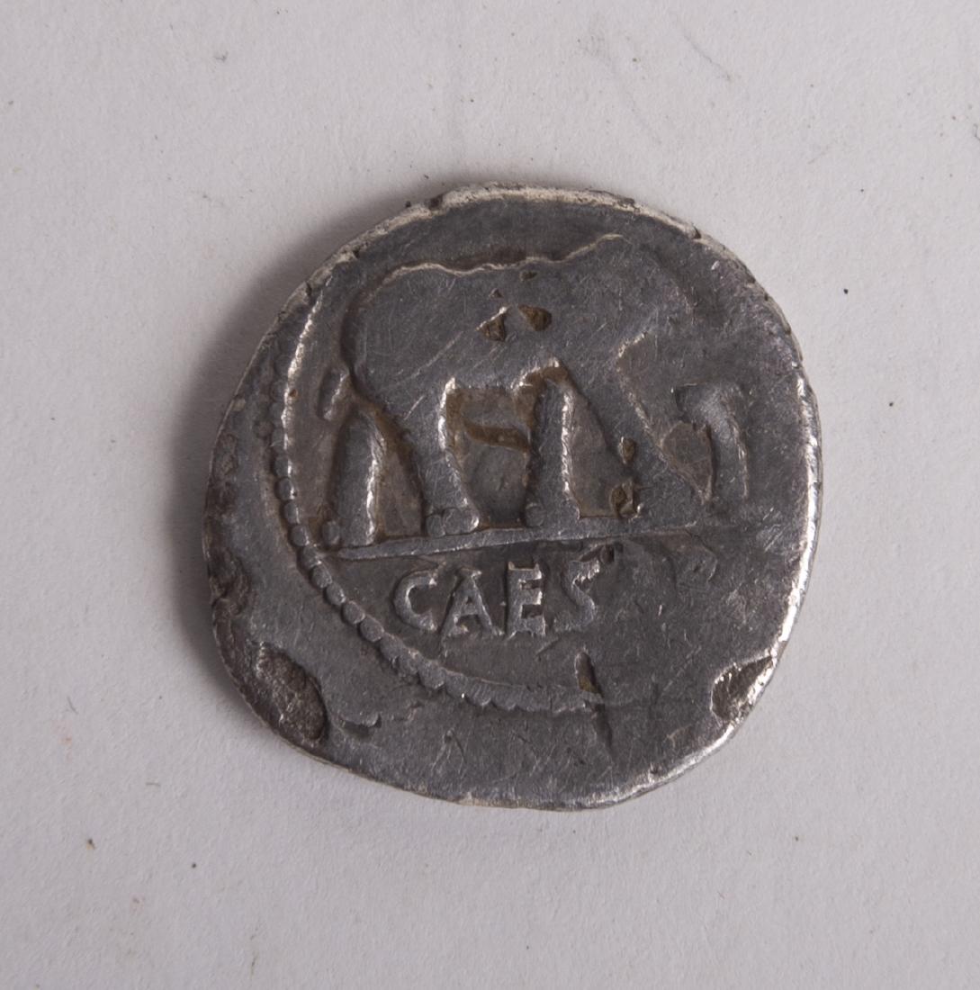 Ancient Julius Caesar. 49-48 BC. AR Silver Denarius: Ancient Julius Caesar. 49-48 BC. AR Silver Denarius (18mm, 3.44 gm). Military mint traveling with Caesar. Elephant advancing right, trampling on horned serpent / Simpulum, aspergillum, securis, and ap